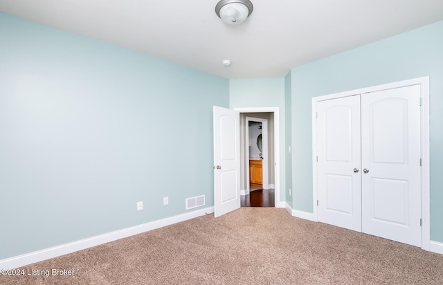 unfurnished bedroom featuring a closet and carpet floors