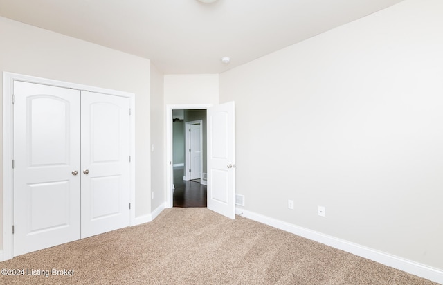 unfurnished bedroom featuring a closet and carpet