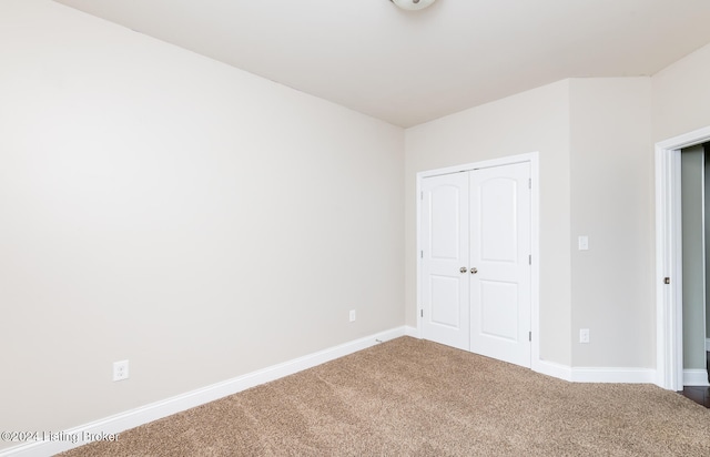 unfurnished bedroom featuring a closet and carpet flooring