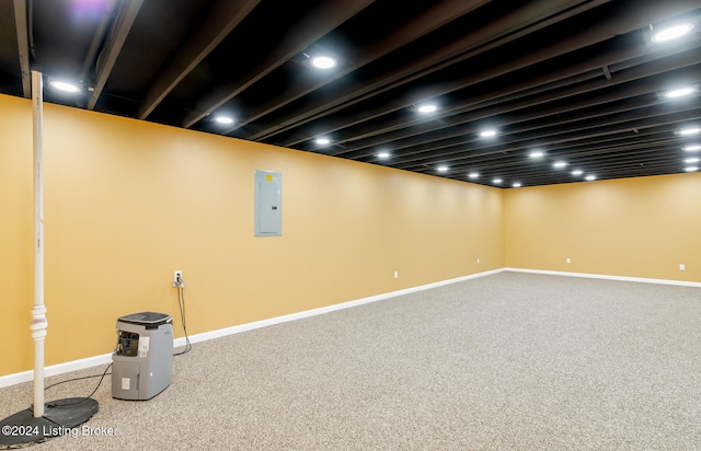 basement featuring electric panel and carpet flooring