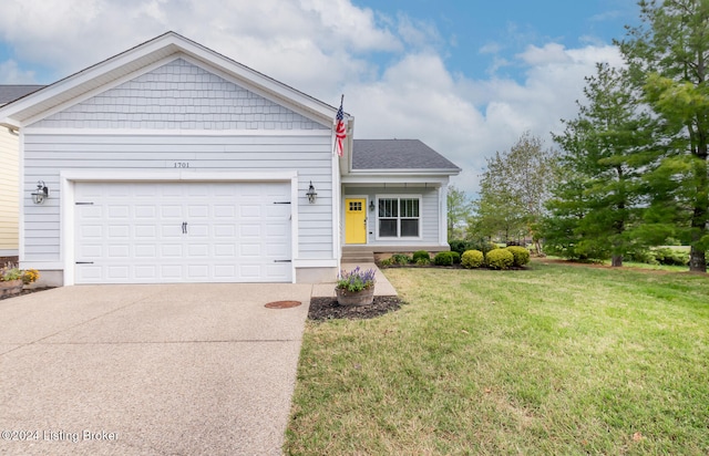 view of front of property featuring a garage and a front lawn