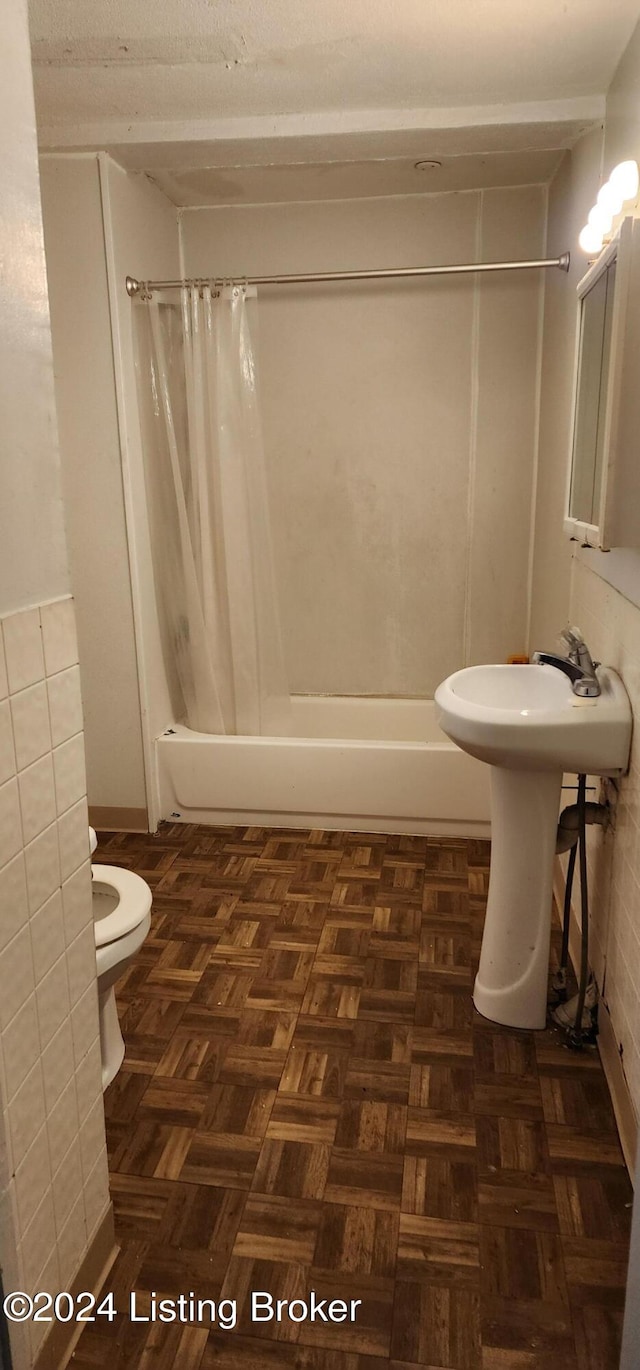 full bathroom with toilet, sink, shower / bath combo with shower curtain, and parquet flooring