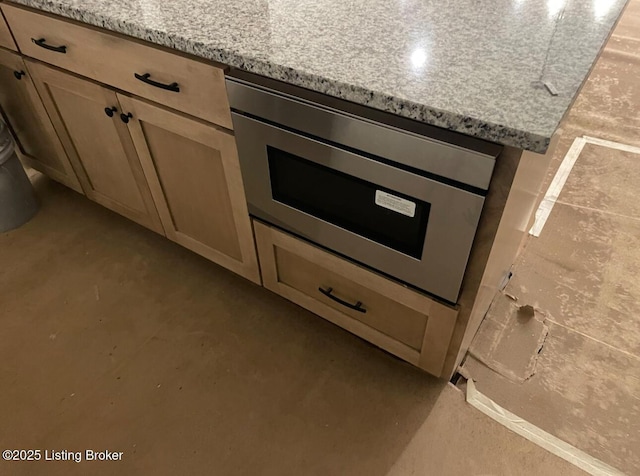 room details with oven and light stone countertops