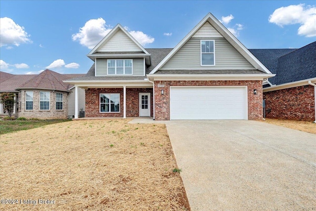 view of front of house featuring a garage and a front lawn