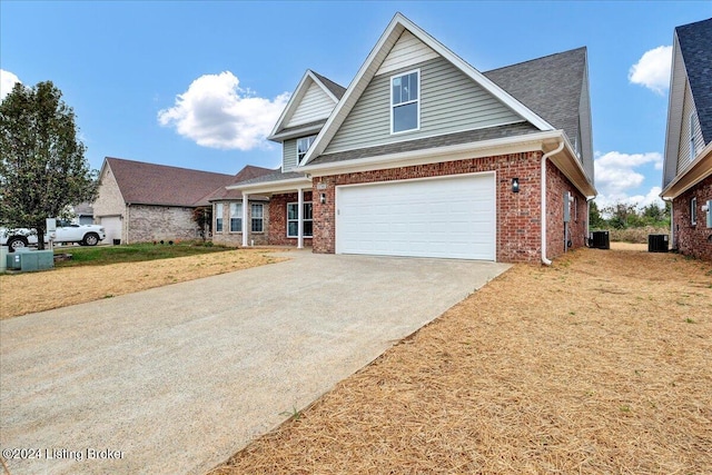 view of front of house with central AC unit and a garage