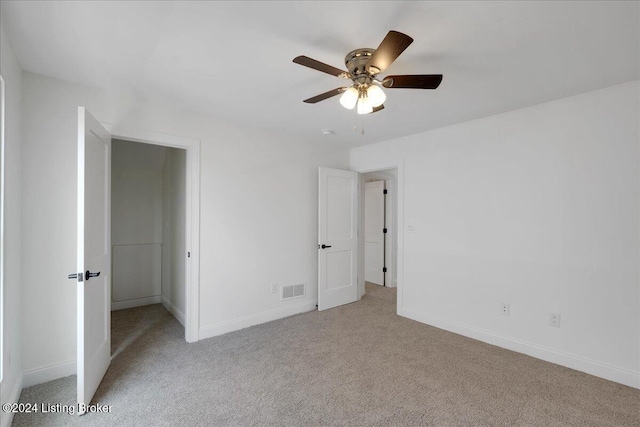 unfurnished bedroom with light carpet and ceiling fan