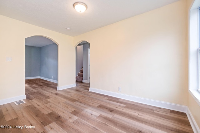 empty room with light hardwood / wood-style floors