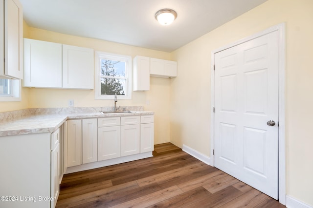 kitchen featuring white cabinets, sink, and dark hardwood / wood-style flooring