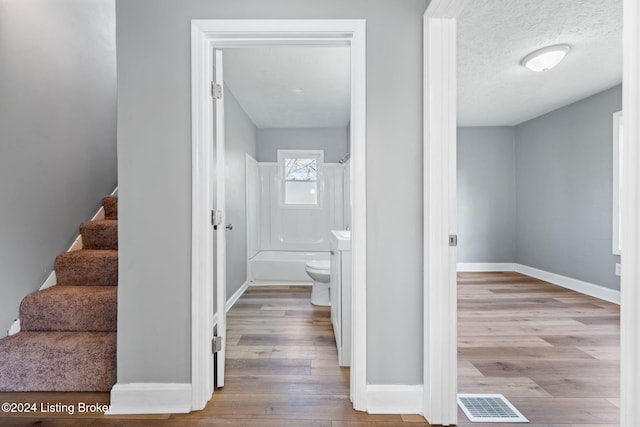 interior space featuring hardwood / wood-style floors and a textured ceiling