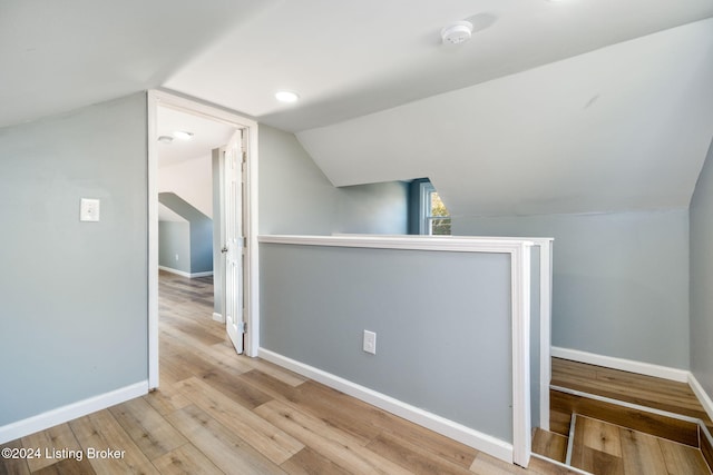 bonus room featuring light hardwood / wood-style flooring and lofted ceiling