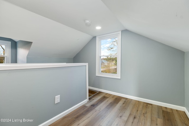 bonus room featuring wood-type flooring and lofted ceiling