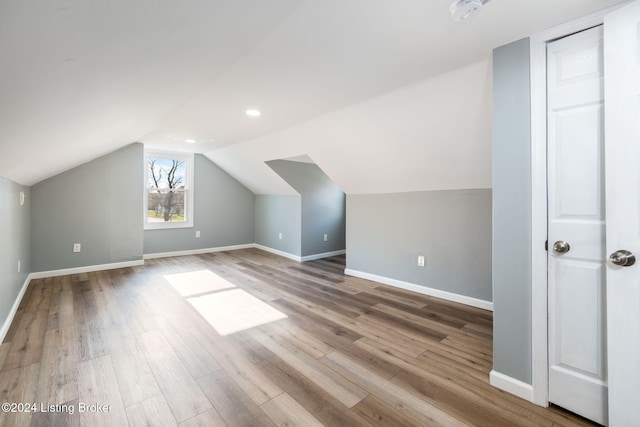 bonus room featuring lofted ceiling and light hardwood / wood-style floors