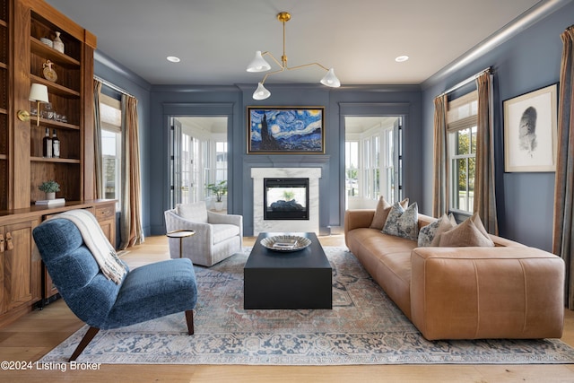 living room featuring light hardwood / wood-style floors and ornamental molding