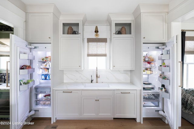 kitchen featuring white cabinetry, a wealth of natural light, sink, and tasteful backsplash