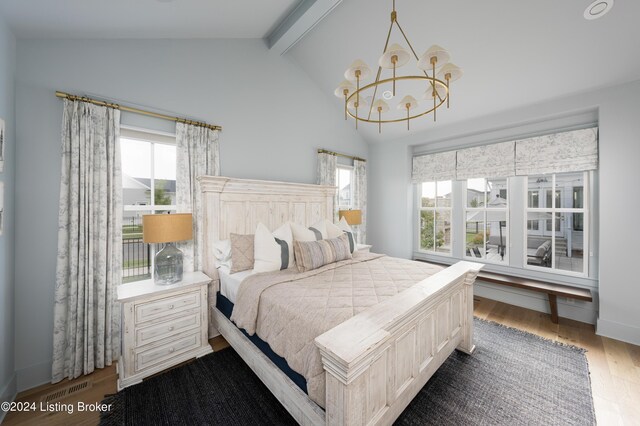 bedroom featuring a chandelier, lofted ceiling with beams, multiple windows, and dark hardwood / wood-style floors