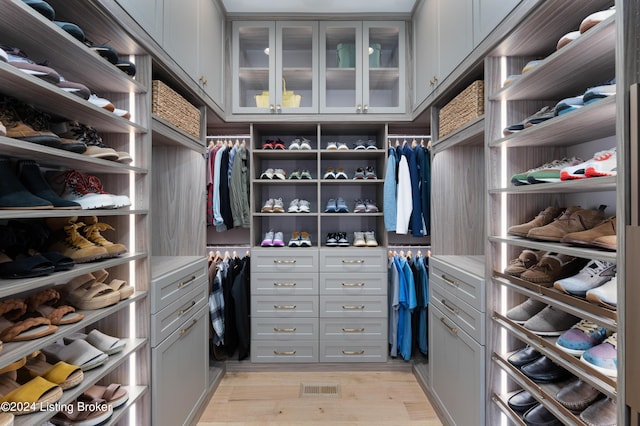 spacious closet featuring light hardwood / wood-style floors