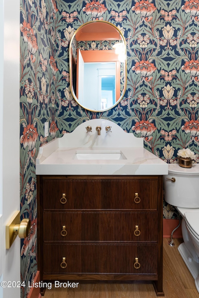 bathroom featuring hardwood / wood-style floors, vanity, and toilet