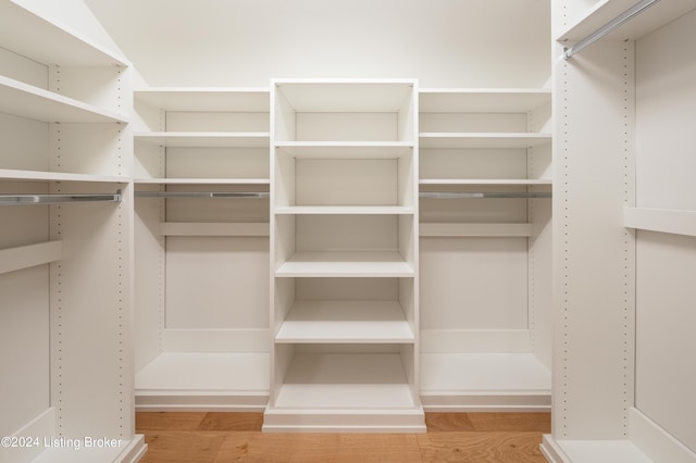 spacious closet with light hardwood / wood-style flooring