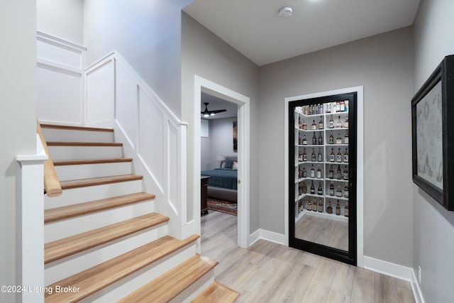 foyer entrance featuring ceiling fan and light hardwood / wood-style flooring