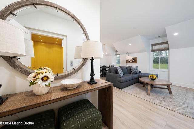 living room with light hardwood / wood-style floors and lofted ceiling