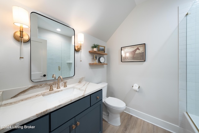 bathroom featuring hardwood / wood-style flooring, vanity, toilet, and vaulted ceiling