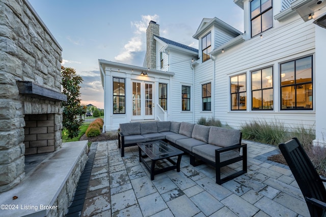 patio terrace at dusk featuring outdoor lounge area