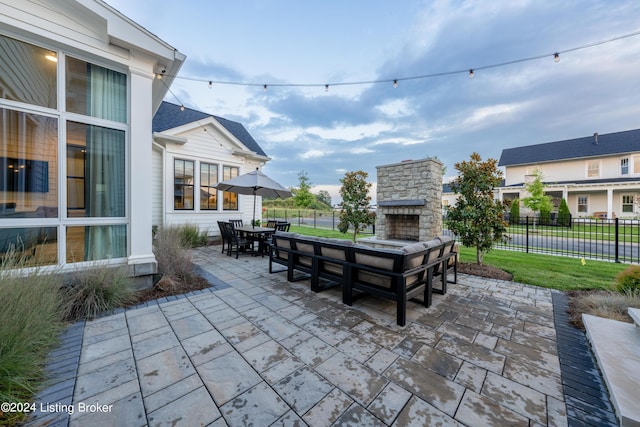 view of patio featuring an outdoor stone fireplace