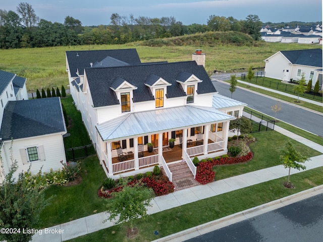 farmhouse with a front lawn and a porch