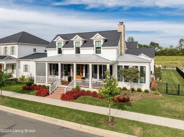 view of front of home with covered porch and a front yard