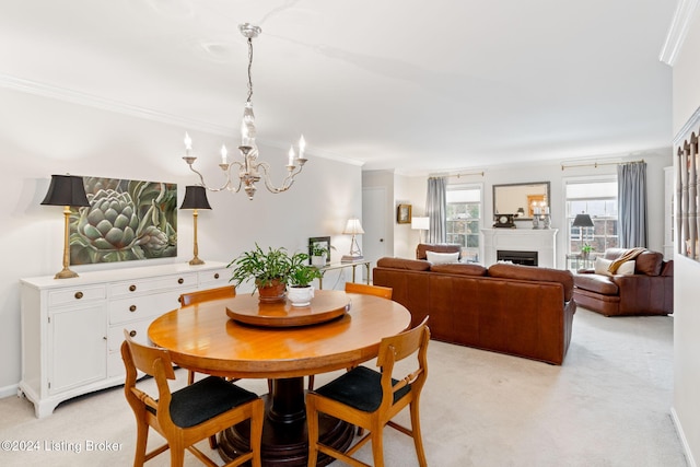 dining room featuring light colored carpet, ornamental molding, and a notable chandelier