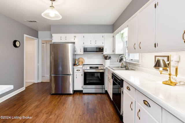 kitchen featuring white cabinetry, stainless steel appliances, hanging light fixtures, and sink