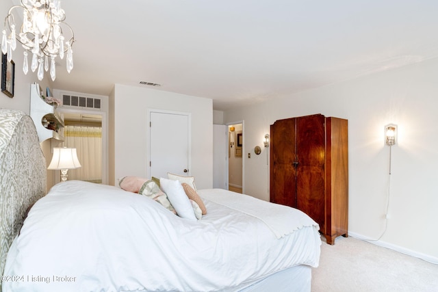 carpeted bedroom with an inviting chandelier