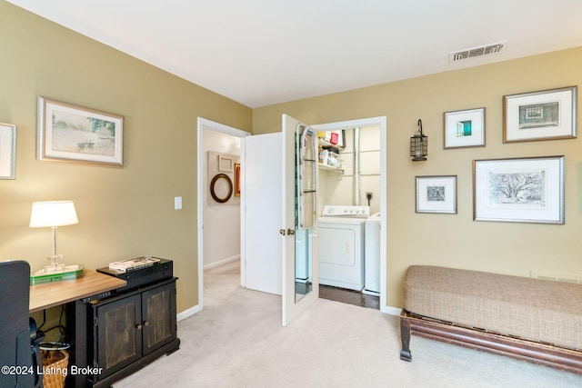 carpeted bedroom with connected bathroom and washing machine and clothes dryer