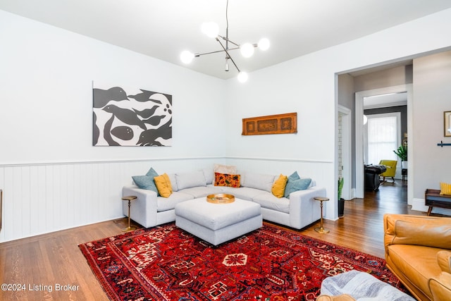 living room with wood-type flooring and a notable chandelier