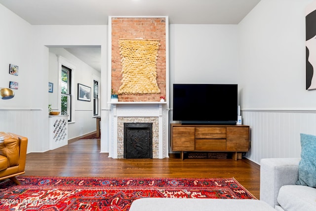 living room with dark hardwood / wood-style floors and a fireplace