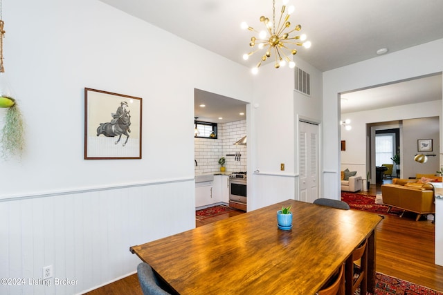 dining area featuring dark hardwood / wood-style floors and a chandelier