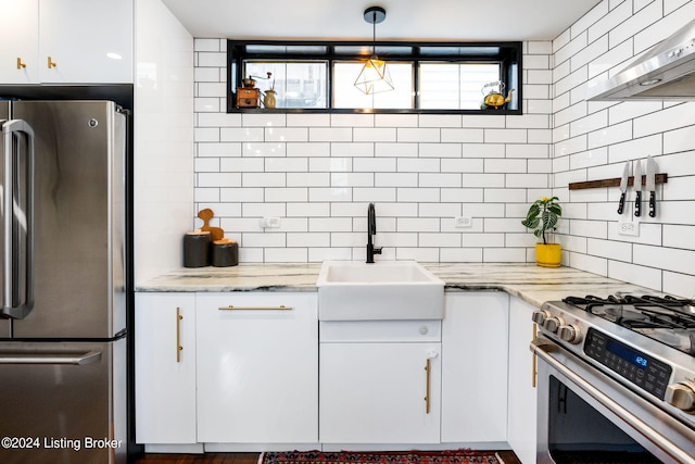 kitchen featuring stainless steel appliances, white cabinetry, and pendant lighting