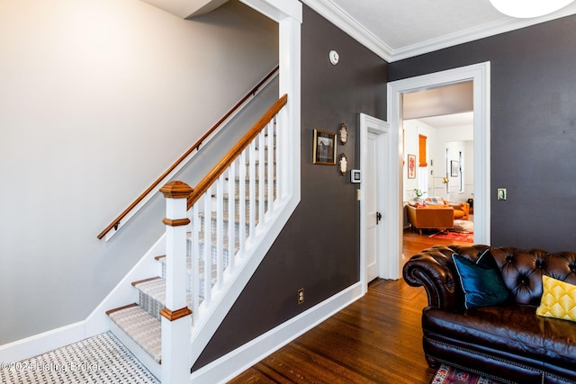 stairs with wood-type flooring and crown molding