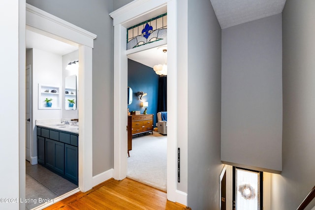 hall featuring sink and light hardwood / wood-style flooring