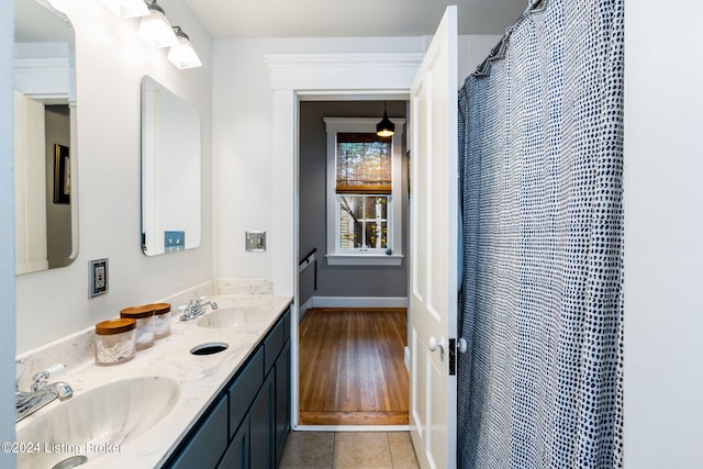 bathroom with hardwood / wood-style flooring, vanity, and walk in shower