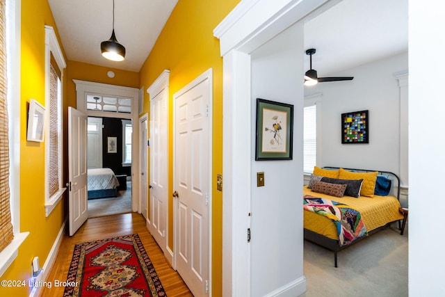 hallway with light hardwood / wood-style floors