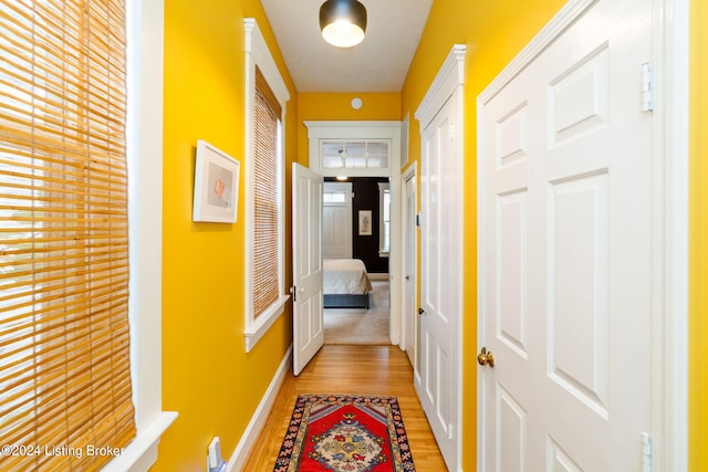 corridor with light wood-type flooring