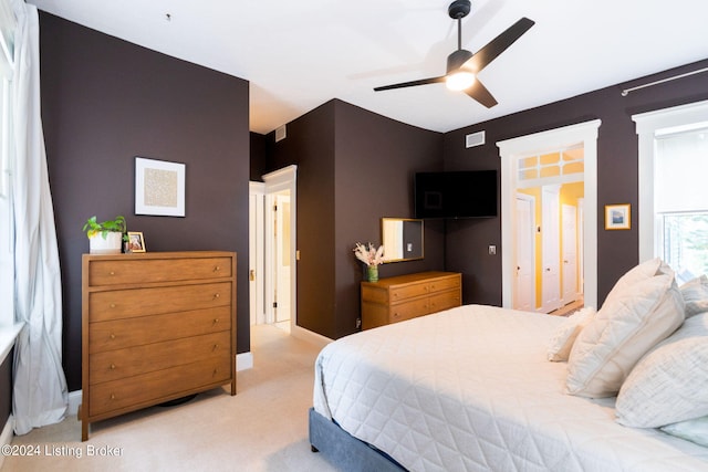 bedroom featuring ceiling fan and light carpet