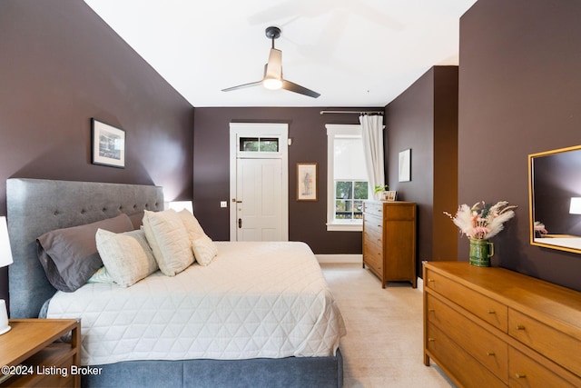 bedroom featuring ceiling fan and light carpet