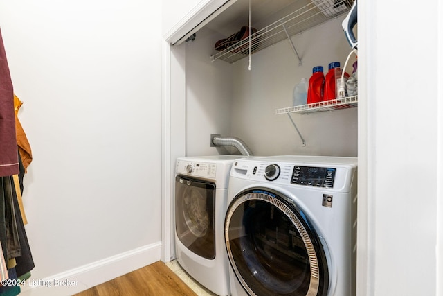 washroom featuring wood-type flooring and washer and dryer