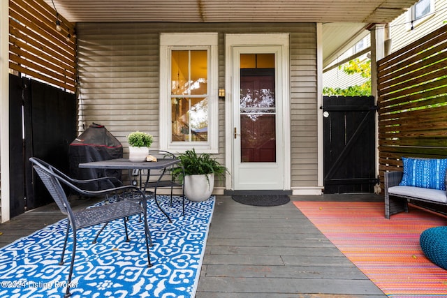 view of exterior entry with a wooden deck