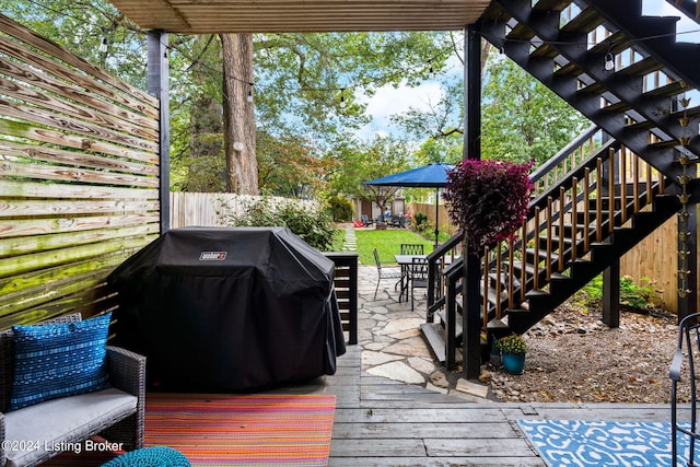 deck featuring grilling area and a pergola