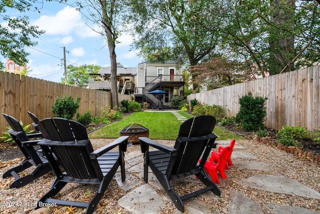 view of patio with an outdoor fire pit and a deck