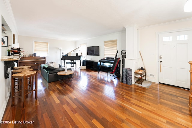 living room featuring hardwood / wood-style flooring and crown molding