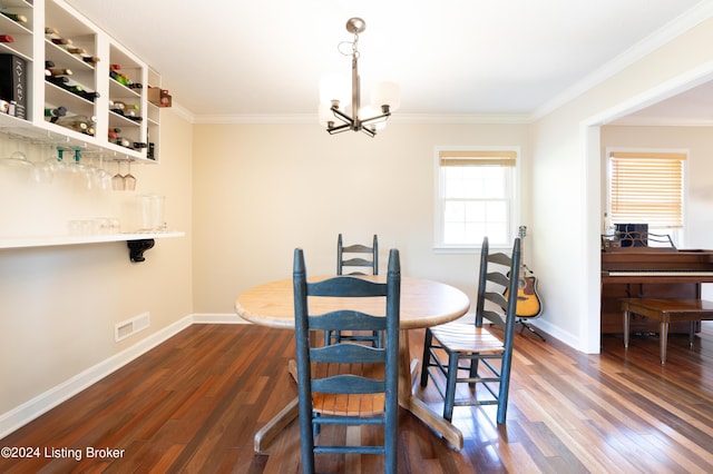 dining space featuring a chandelier, dark hardwood / wood-style floors, and crown molding